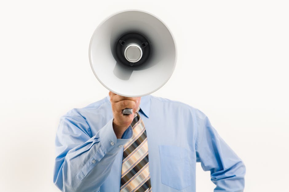 Businessman in blue shirt holding megaphone